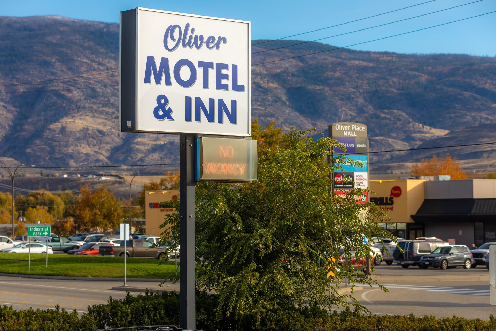 A large red and yellow building with mountains in the background.