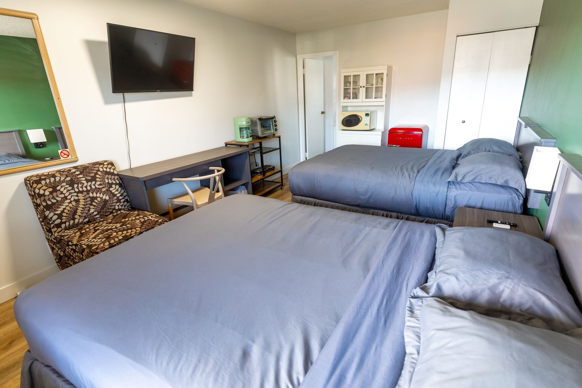 A hotel room with two beds , a table and chairs.