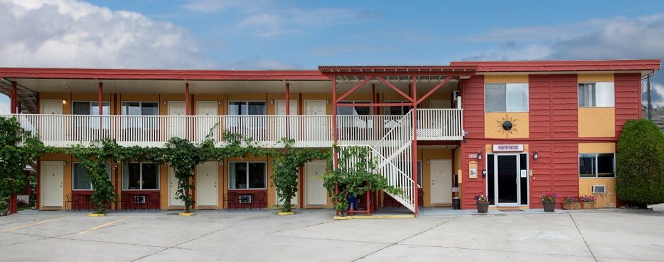 A large red and yellow building with a lot of windows and balconies.