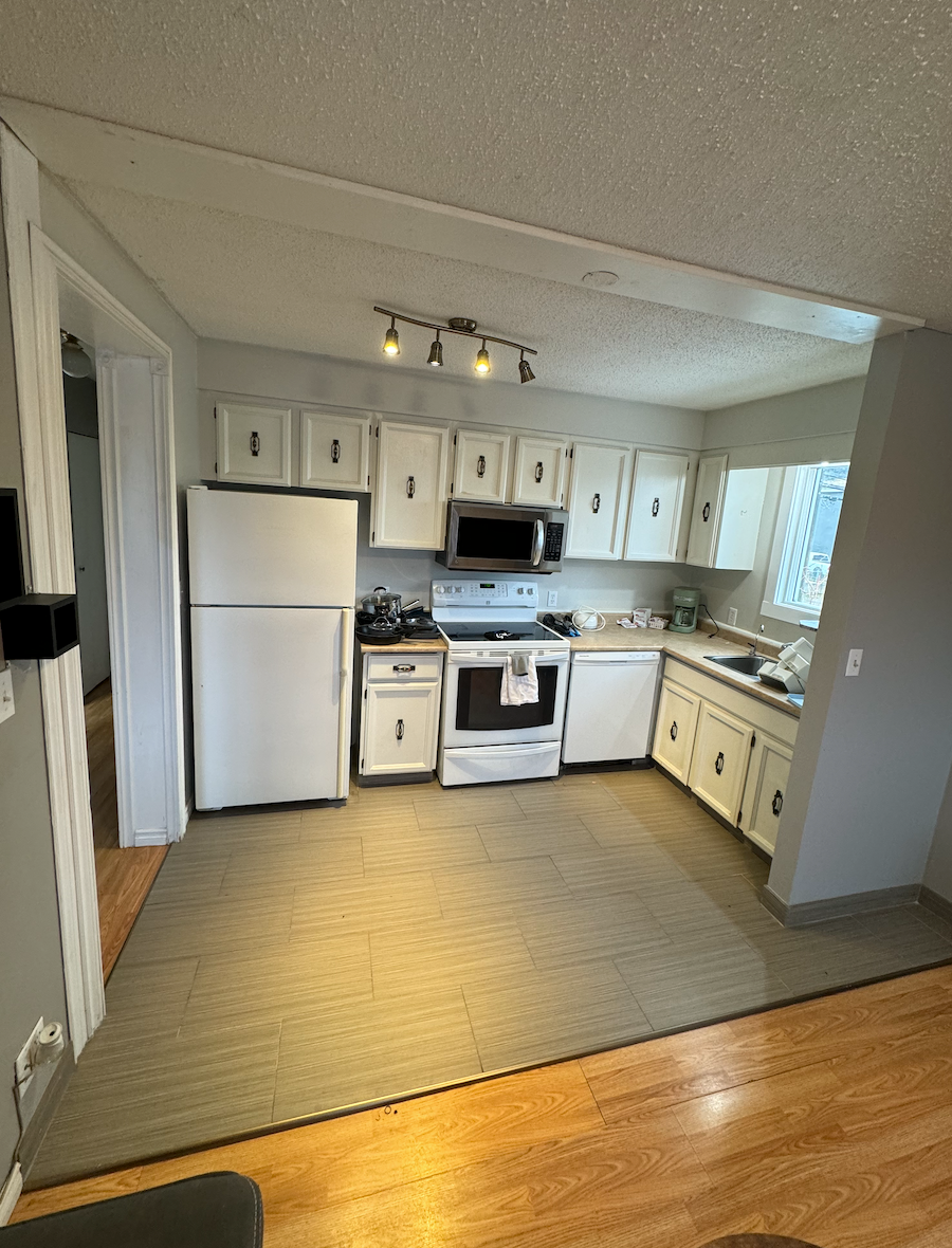 A kitchen with a refrigerator , stove , dishwasher , and microwave.