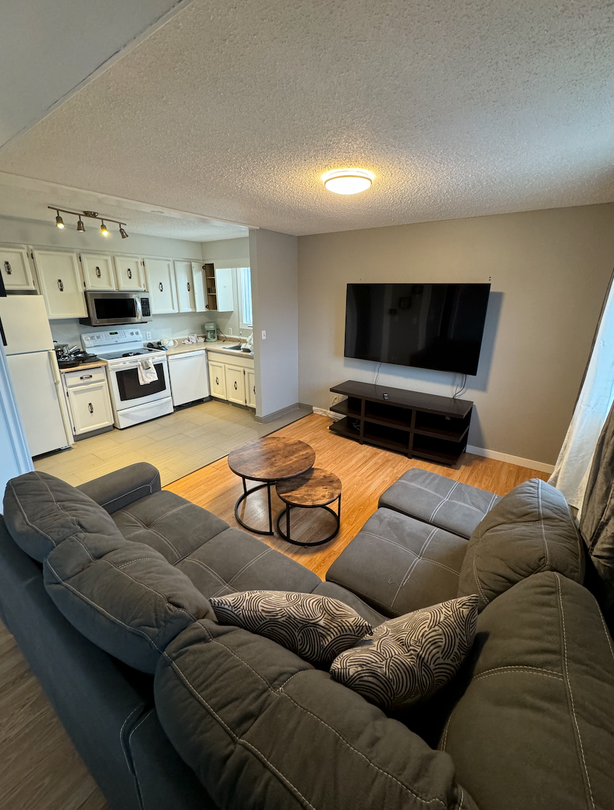 A living room with a couch and a flat screen tv.