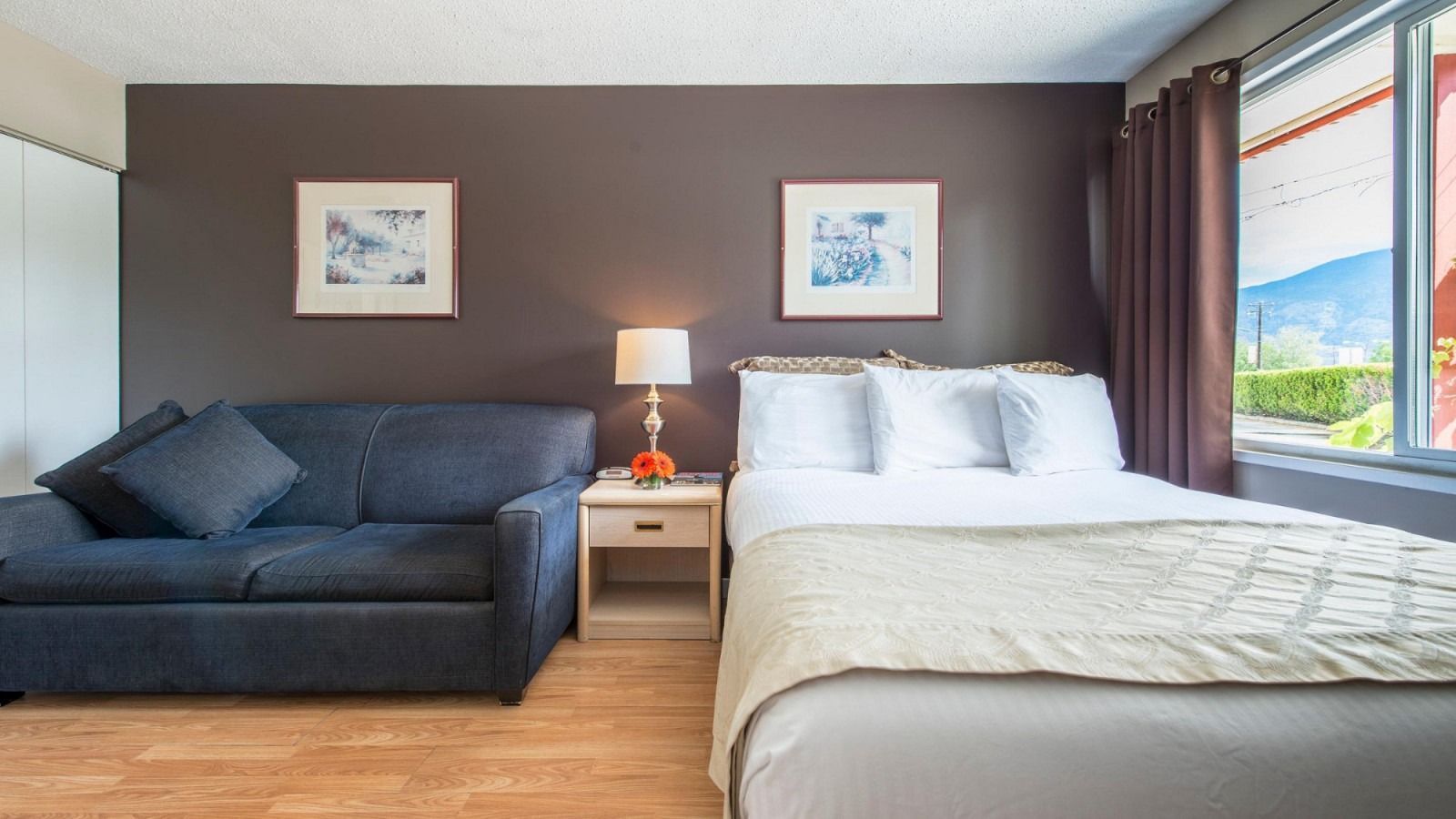 There is a bed and a couch in the room.