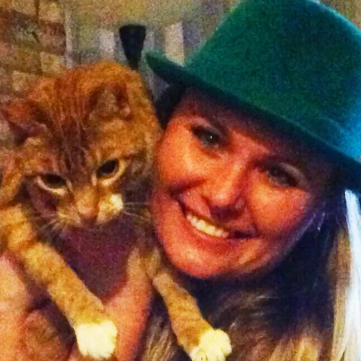 A man in a suit and tie is smiling in front of a window