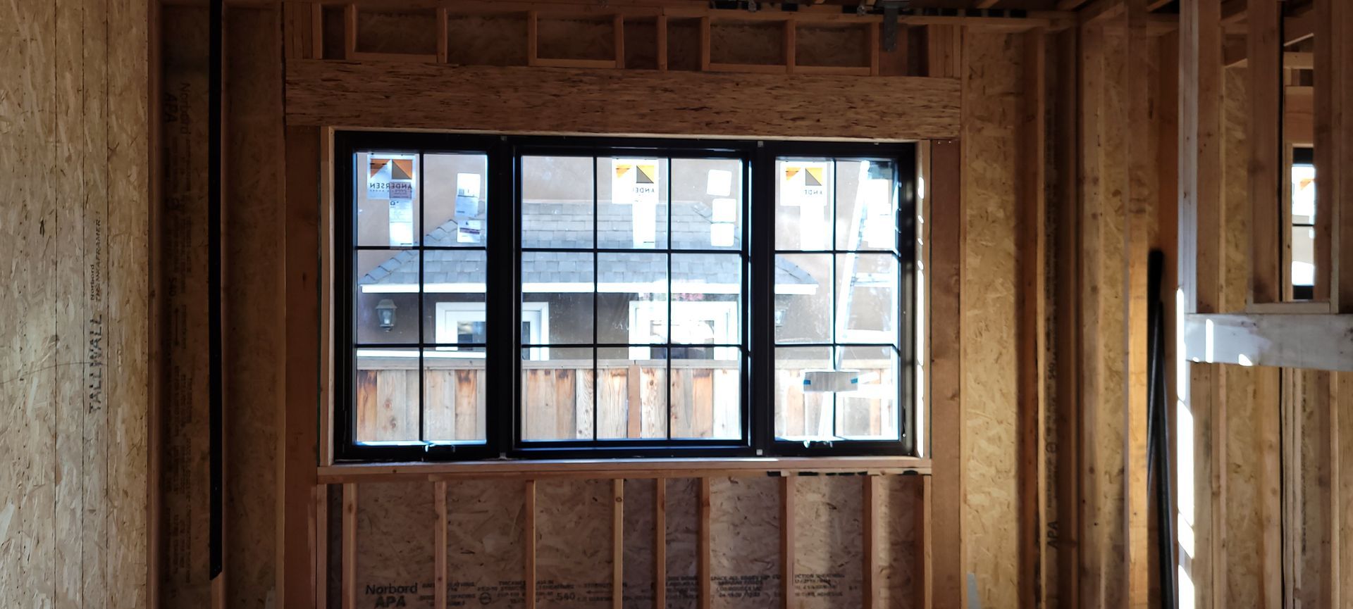 Window with sheer curtains, sunlight filtering through, illuminating the room.