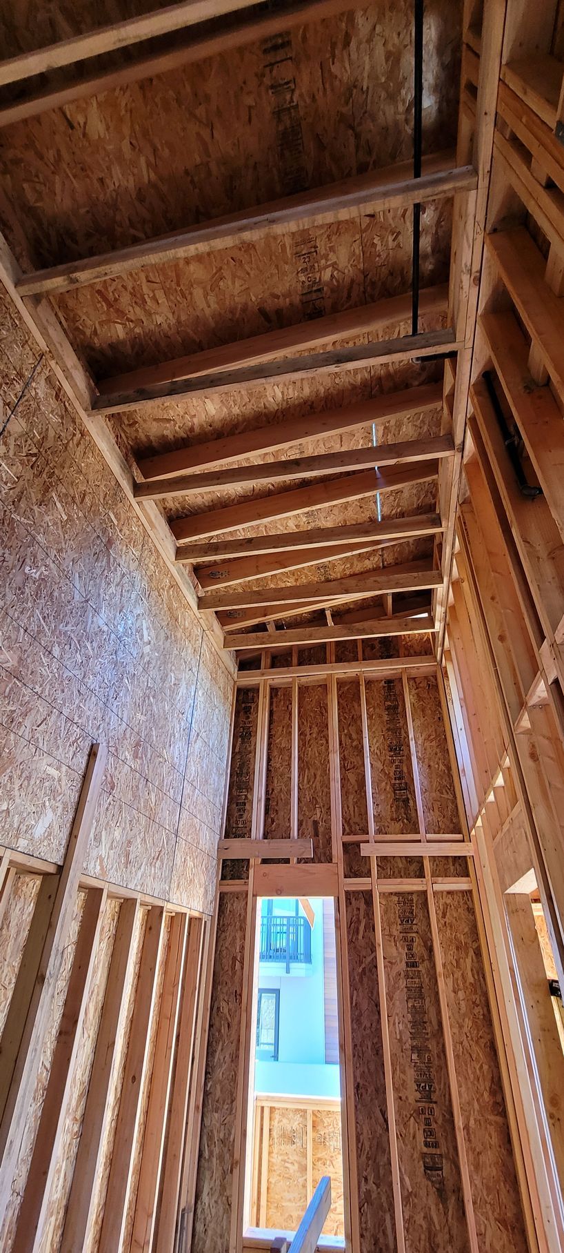 Interior view of wood framing in a building under construction. 