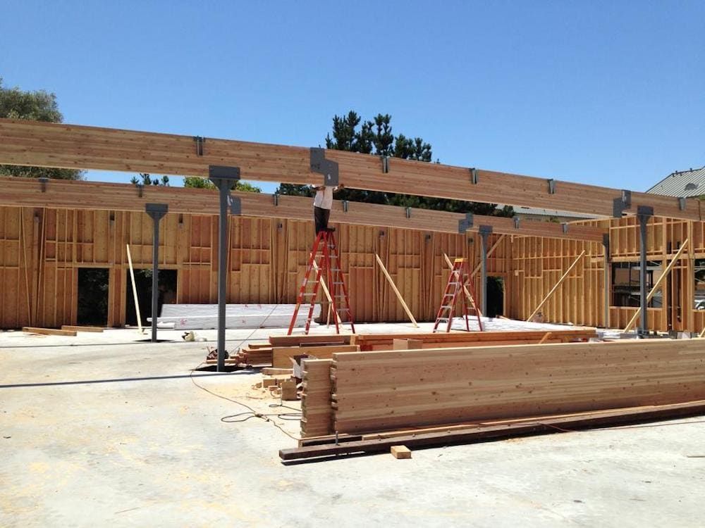 Construction site with wooden beams and supporting structures.