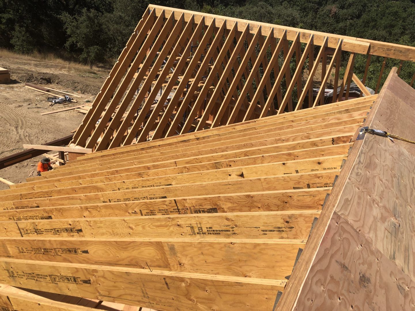 Wooden roof framing under construction.