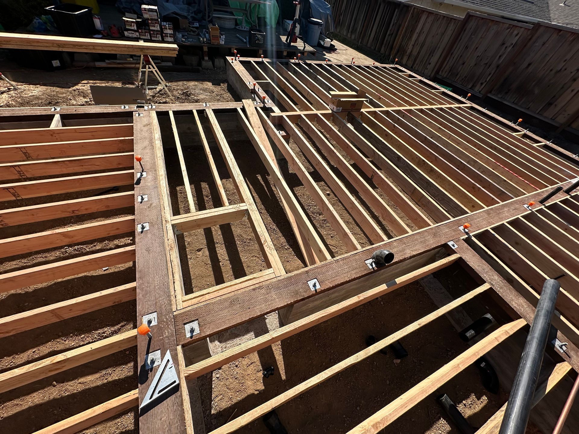 Wooden deck frame under construction outdoors. 