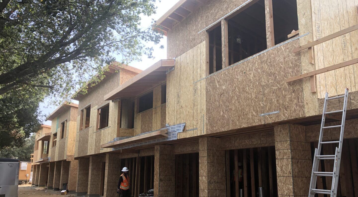 Townhouses under construction, wood-framed with OSB siding.
