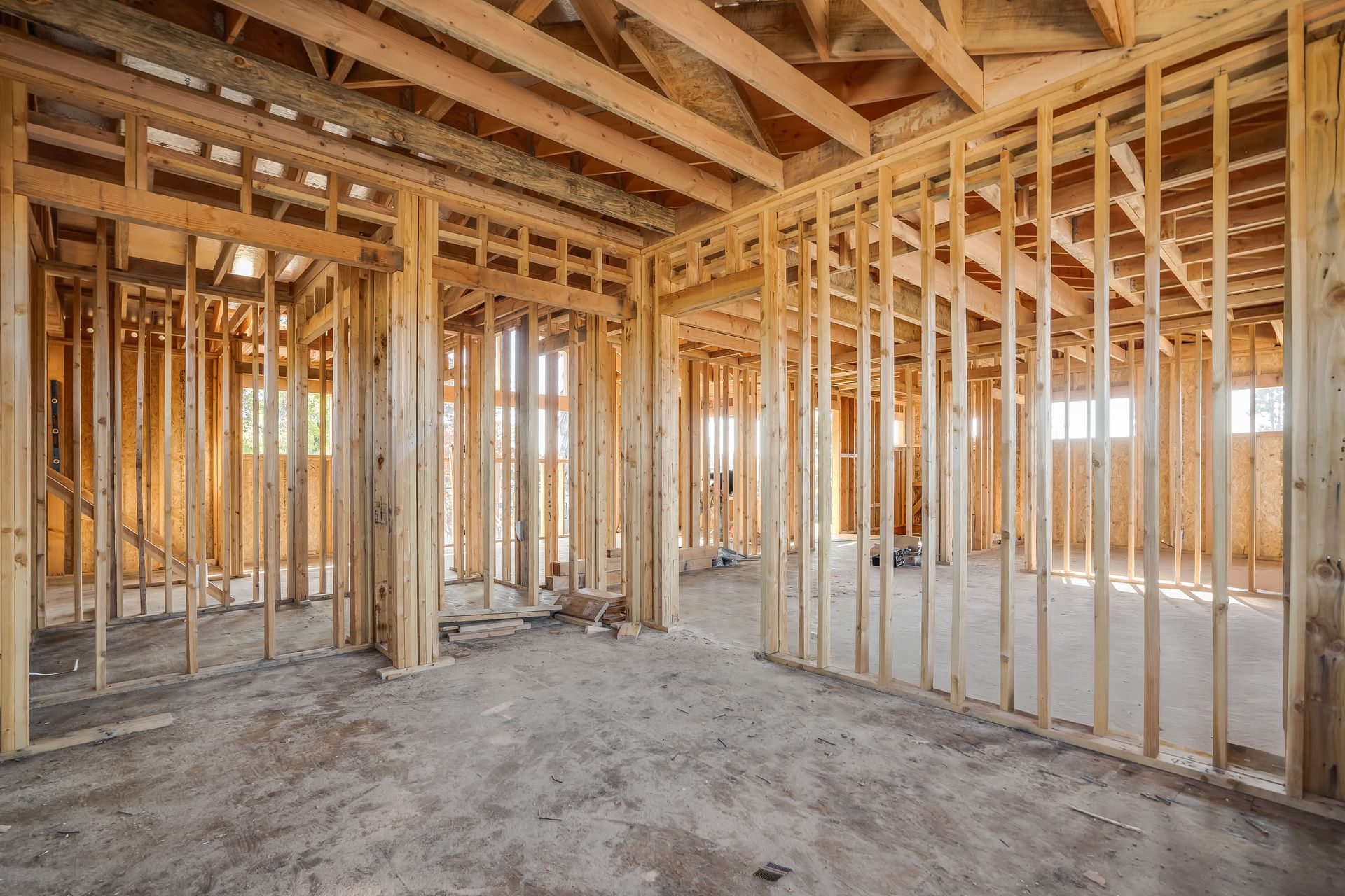 Interior view of a building under construction, wooden framework of walls and roof.
