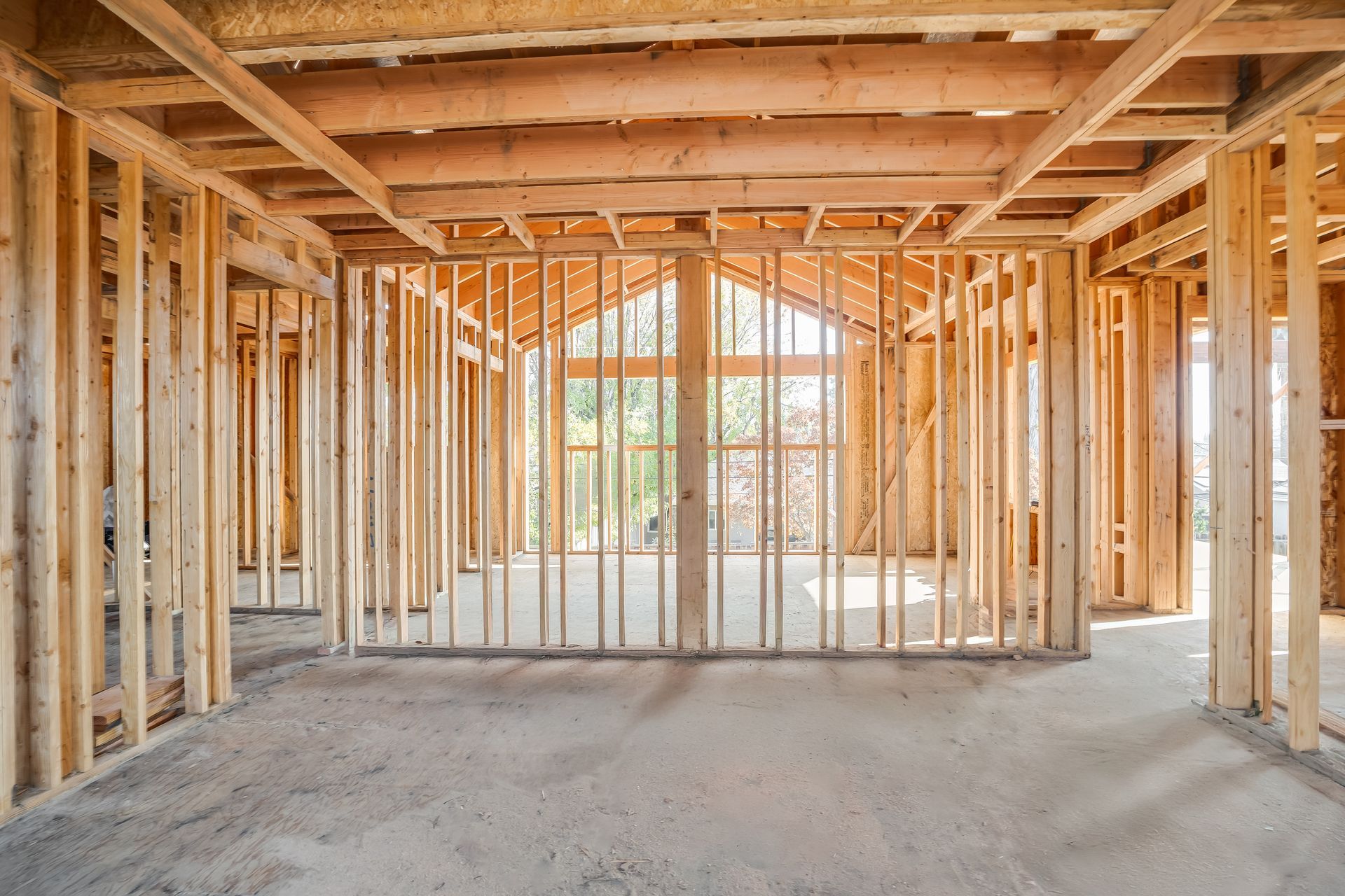 Interior of a building under construction, wooden framework with a view of the outside through a window.