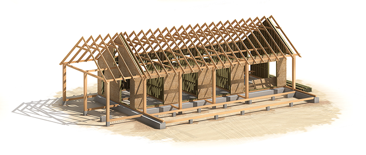 Wooden framework of a building under construction, showing roof trusses, posts, and foundation blocks on a tan surface.