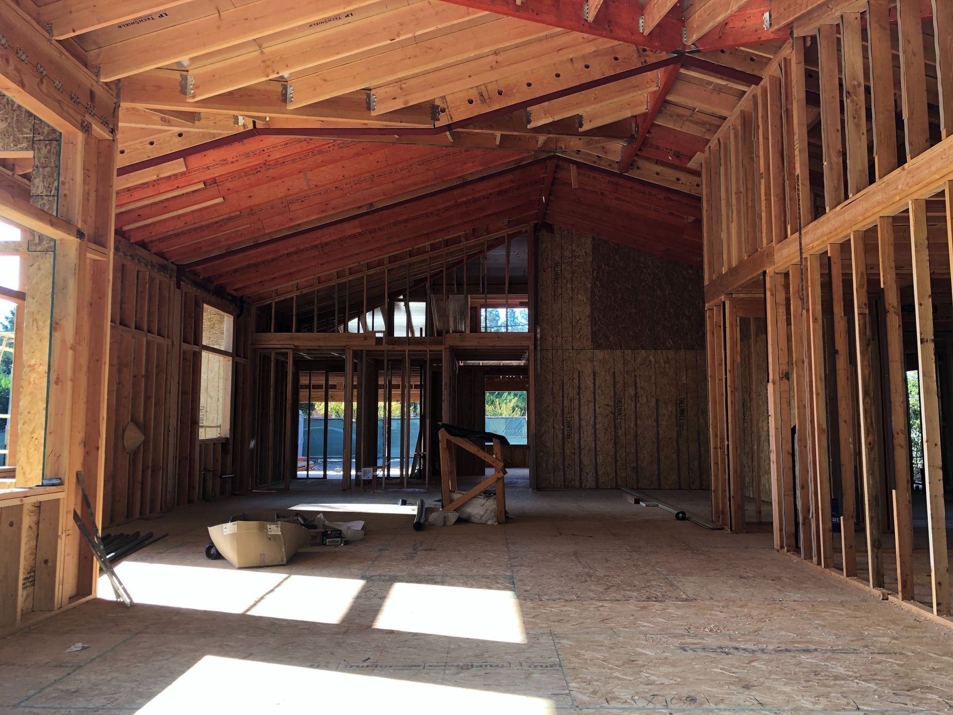 Interior view of a building under construction, showing wooden framing and an unfinished roof.