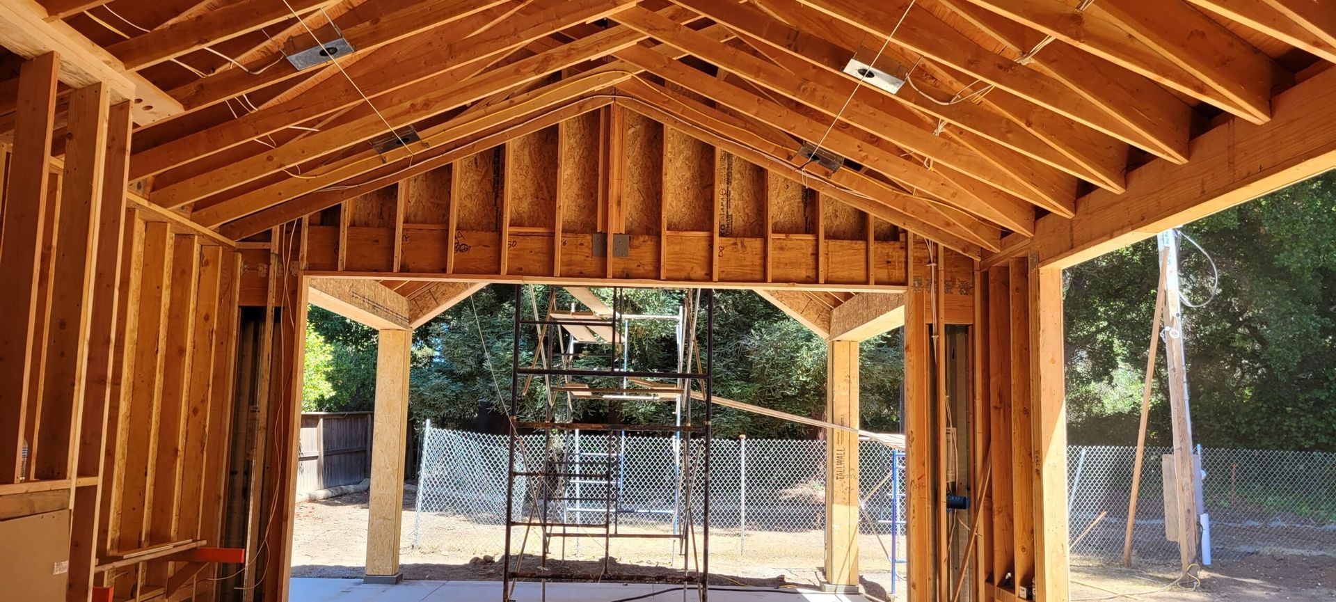 Interior view of a building under construction, showing wooden framework. 