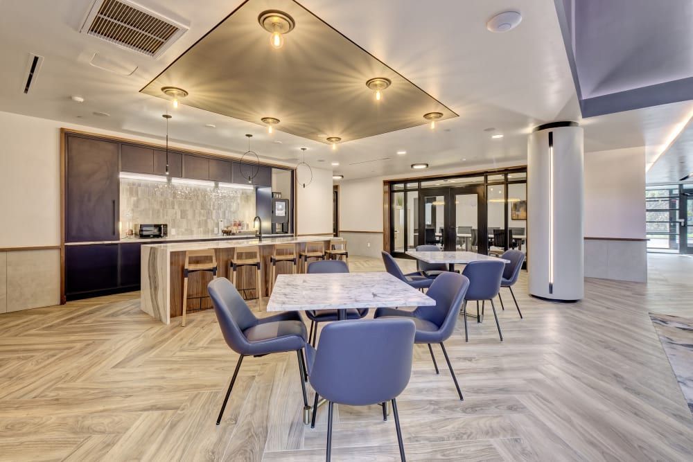 A large room with tables and chairs in it.