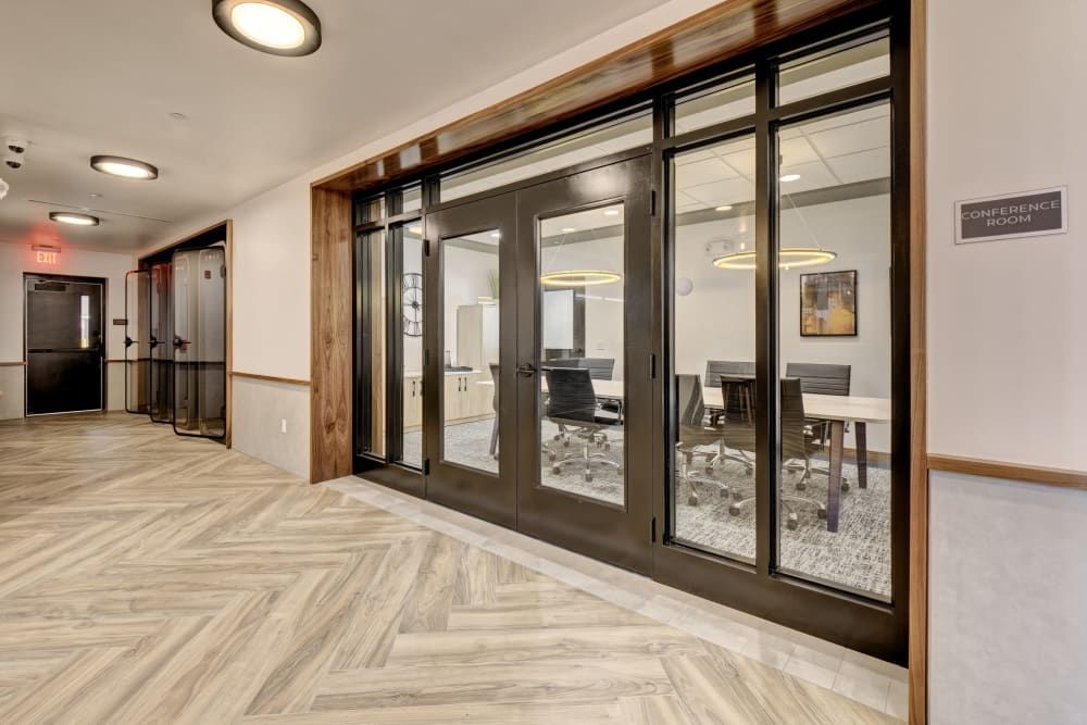 A long hallway with a conference room in the background.