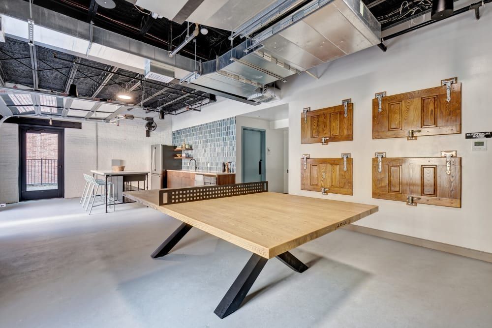 There is a ping pong table in the middle of the room.