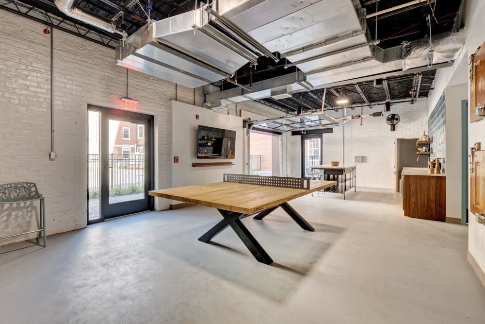 There is a ping pong table in the middle of the room.