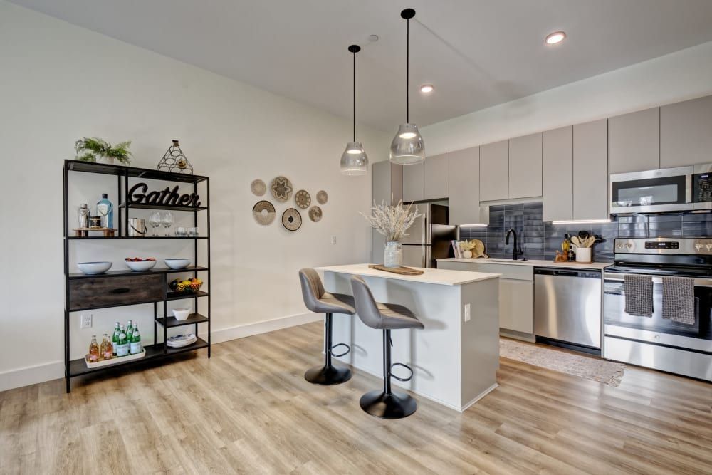 A kitchen with stainless steel appliances and a large island.