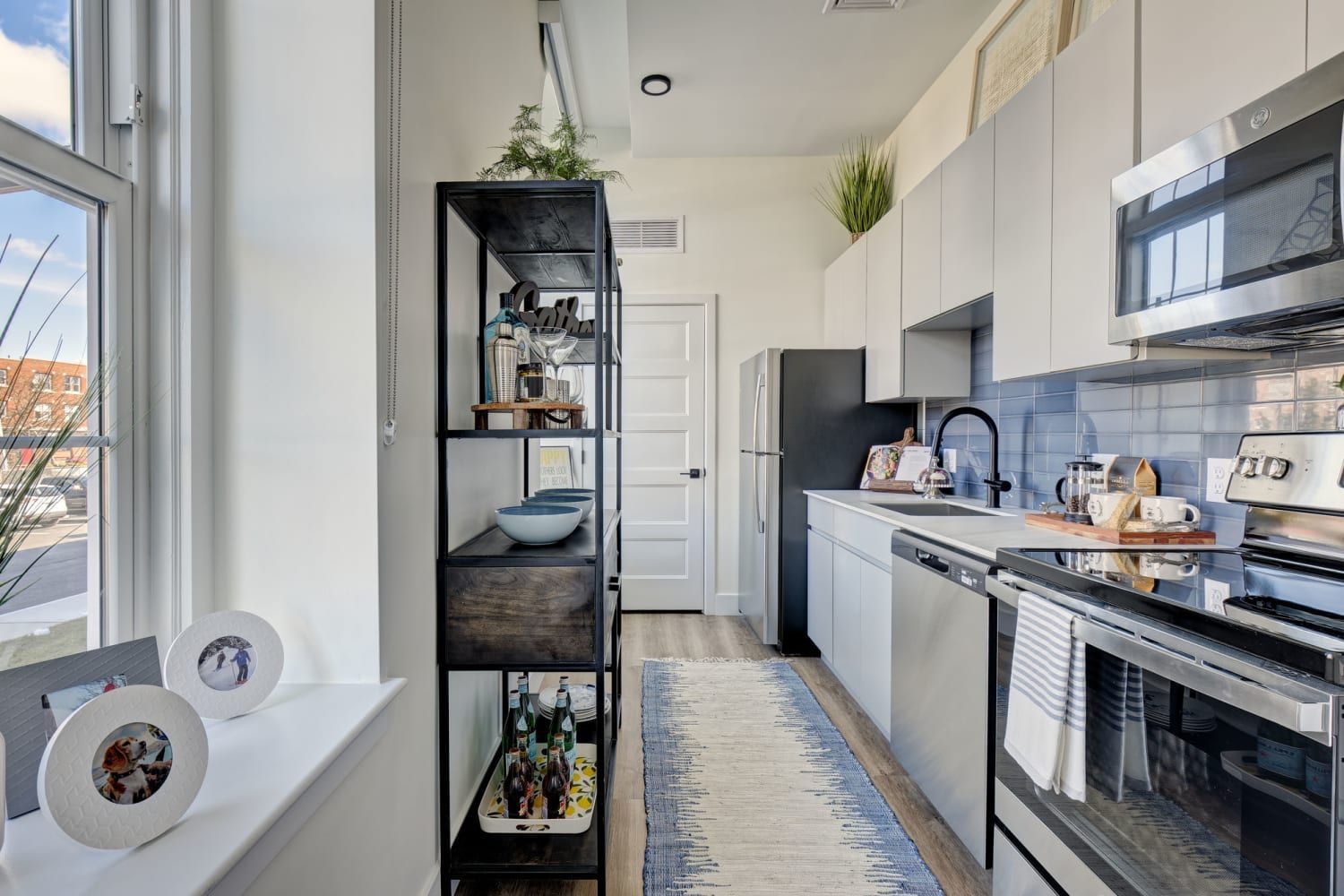 A kitchen with stainless steel appliances and white cabinets.