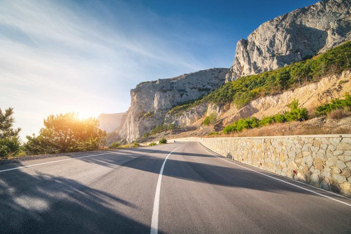 asphalt road in summer at sunrise