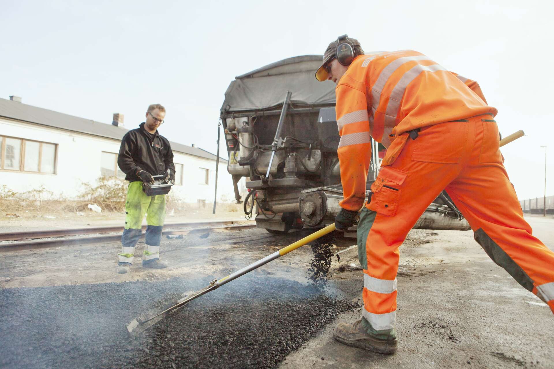 workers paving at road construction site