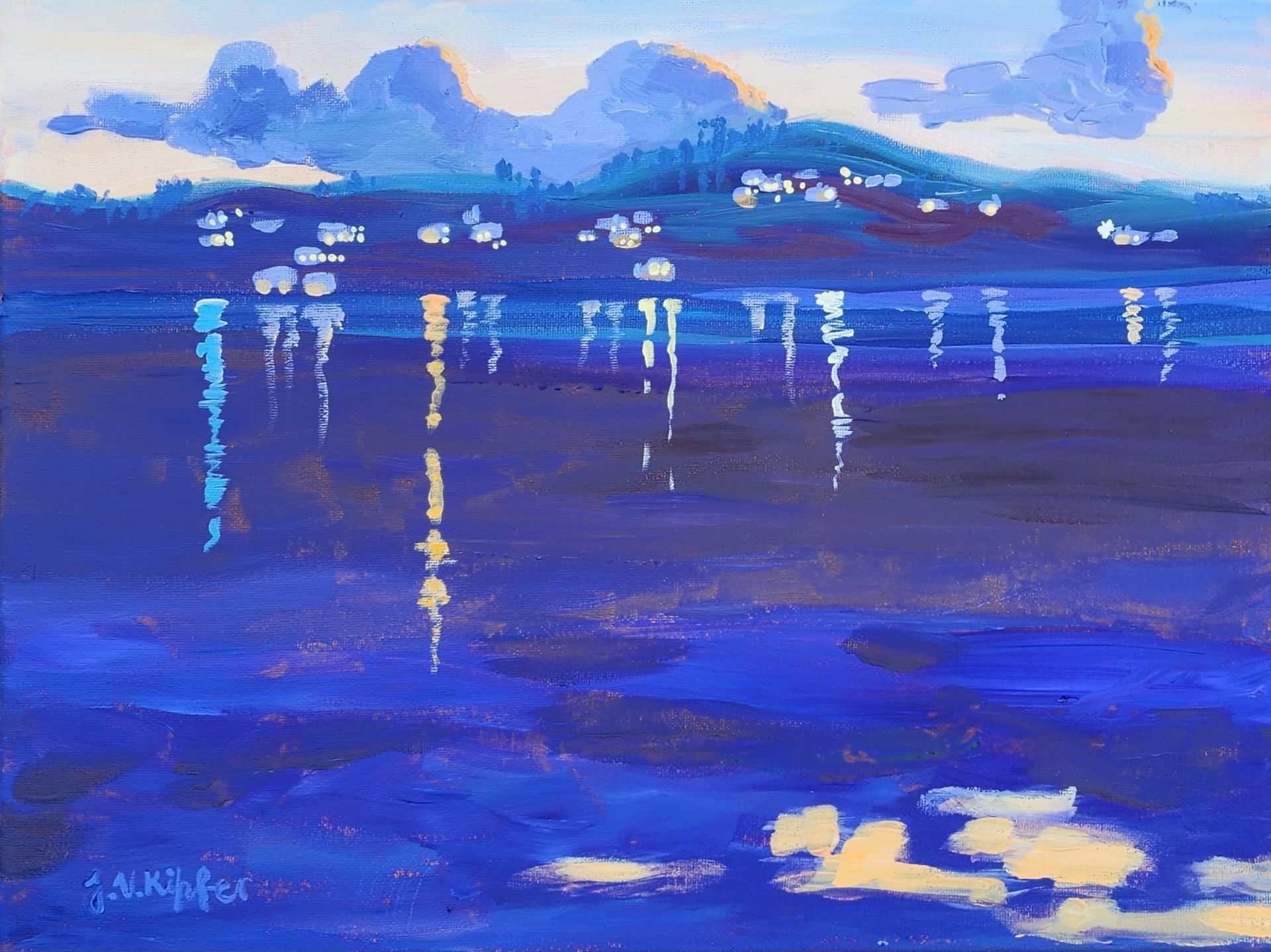 Blue waters reflect lights and mountains, with a town nestled beneath clouds.