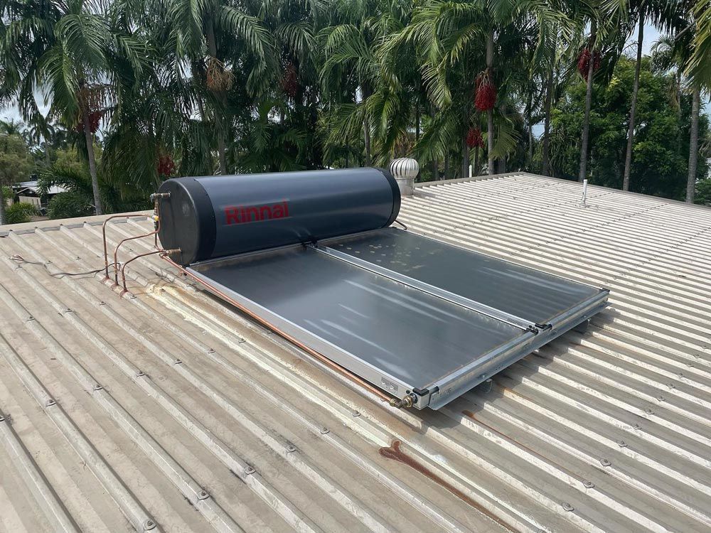 A Solar Water Heater is Sitting on Top of a Roof — Absolute Plumbing Australia in Darwin, NT