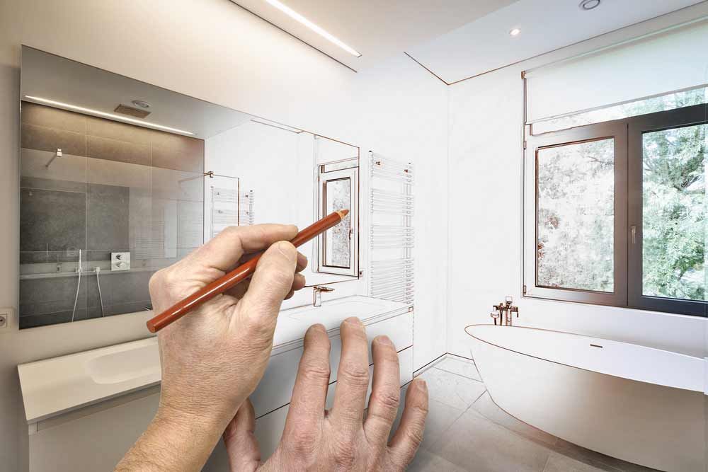 A Person is Drawing a Bathroom With a Pencil — Absolute Plumbing Australia in Darwin, NT