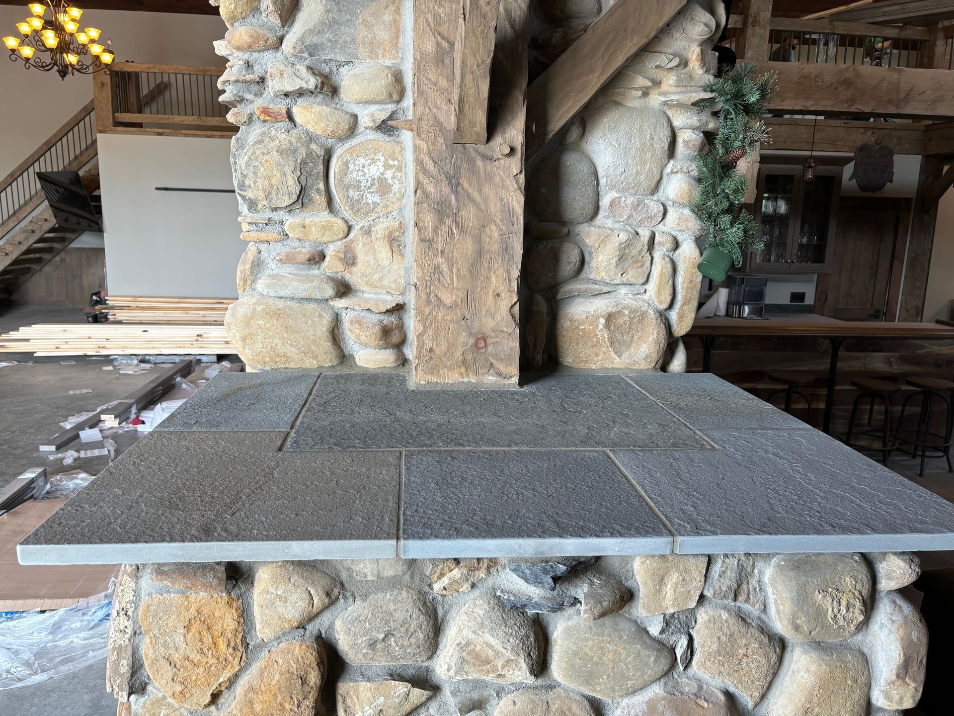 A man is laying bricks on the side of a house.