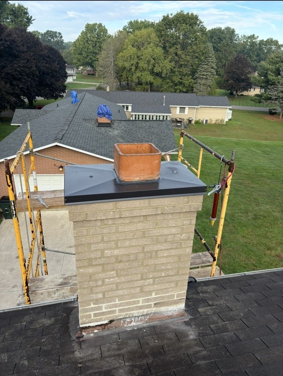 A brick chimney on top of a roof.