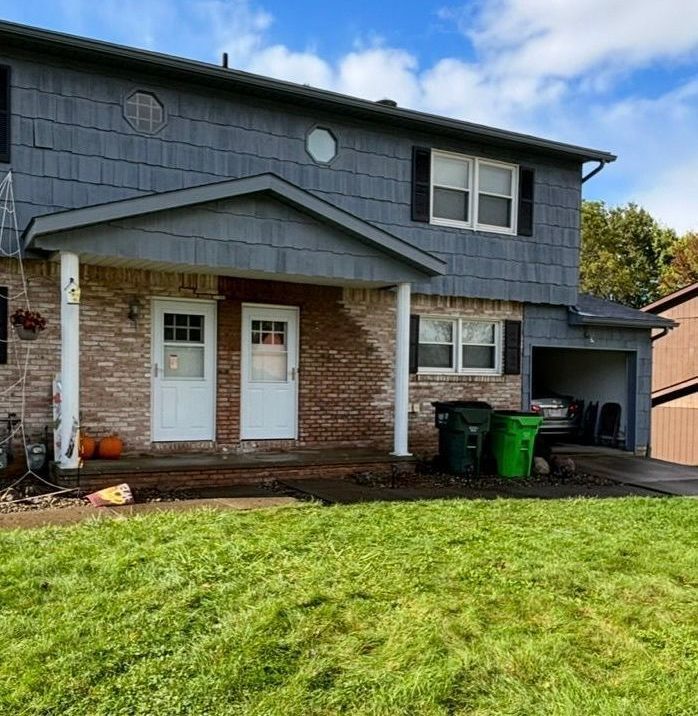 A large house with a large lawn in front of it.