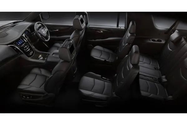 The interior of a car with black leather seats and a steering wheel.