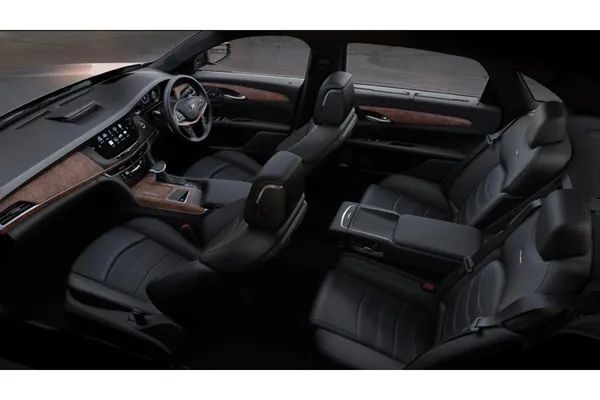 The interior of a car with black leather seats and wooden trim.