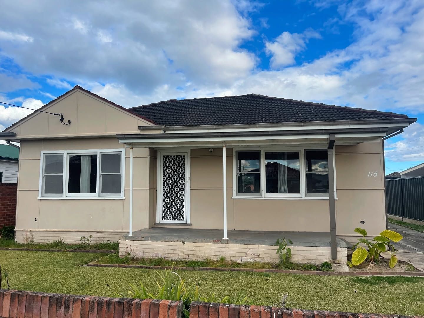 Beige Single-story House With a Small Porch and Dark Roof — Ecowave Solutions In Gosford, NSW