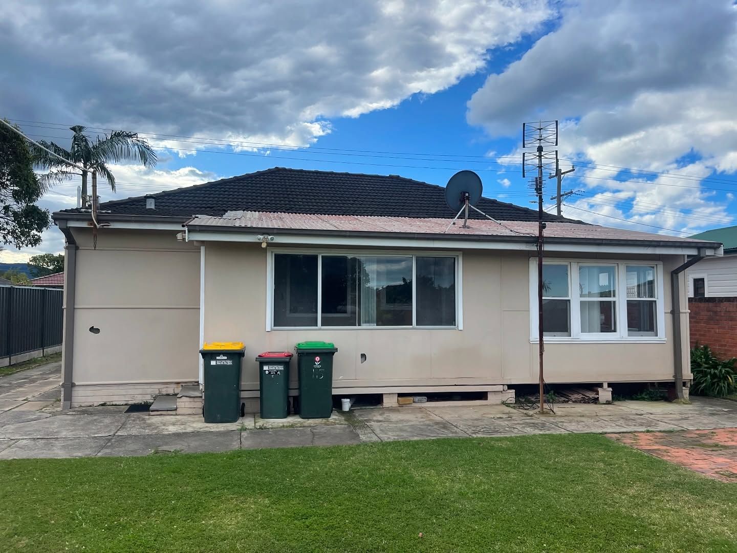 Backyard View of a Beige House With a Dark Roof — Ecowave Solutions In Gosford, NSW