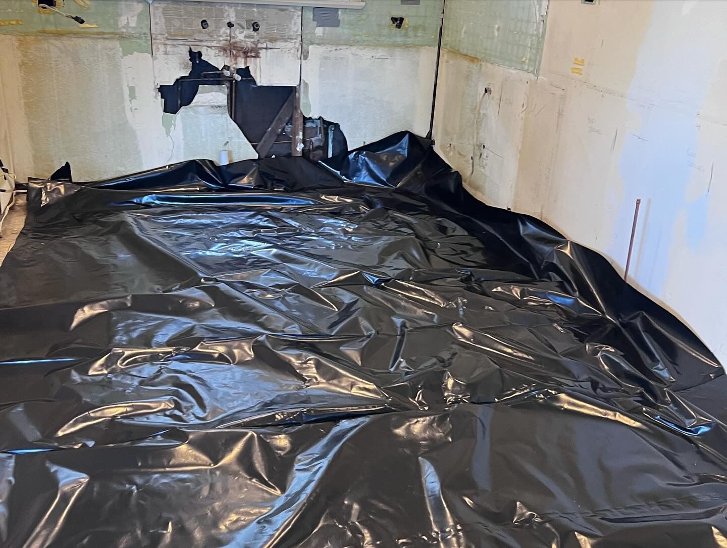 Room With Walls and Floor Covered in Black Plastic Sheeting — Ecowave Solutions In Gosford, NSW