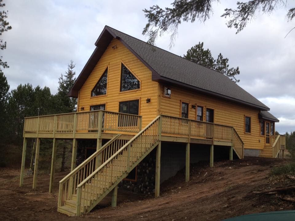 A large house with a large deck and stairs