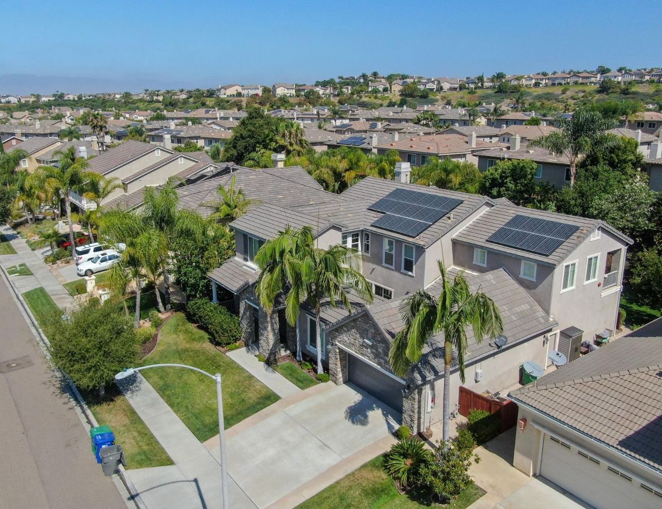 An aerial view of a house with solar panels on the roof