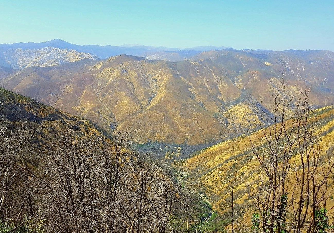 A view of a valley with mountains in the background