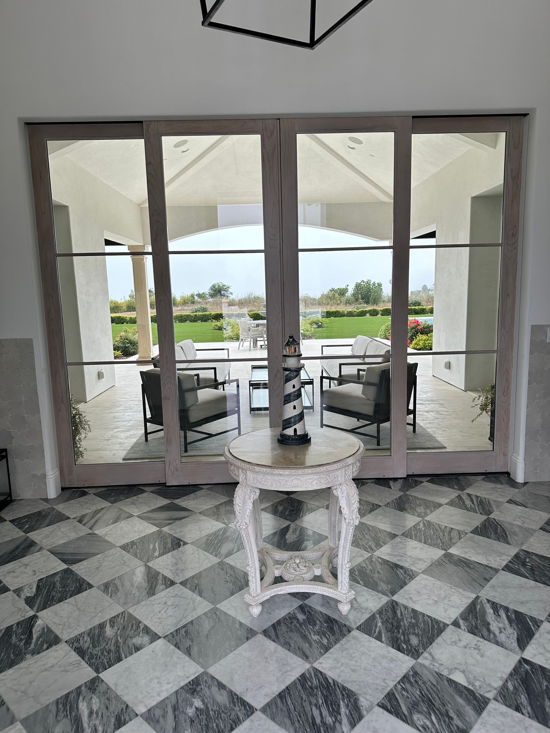 A room with a checkered floor and a table in the middle