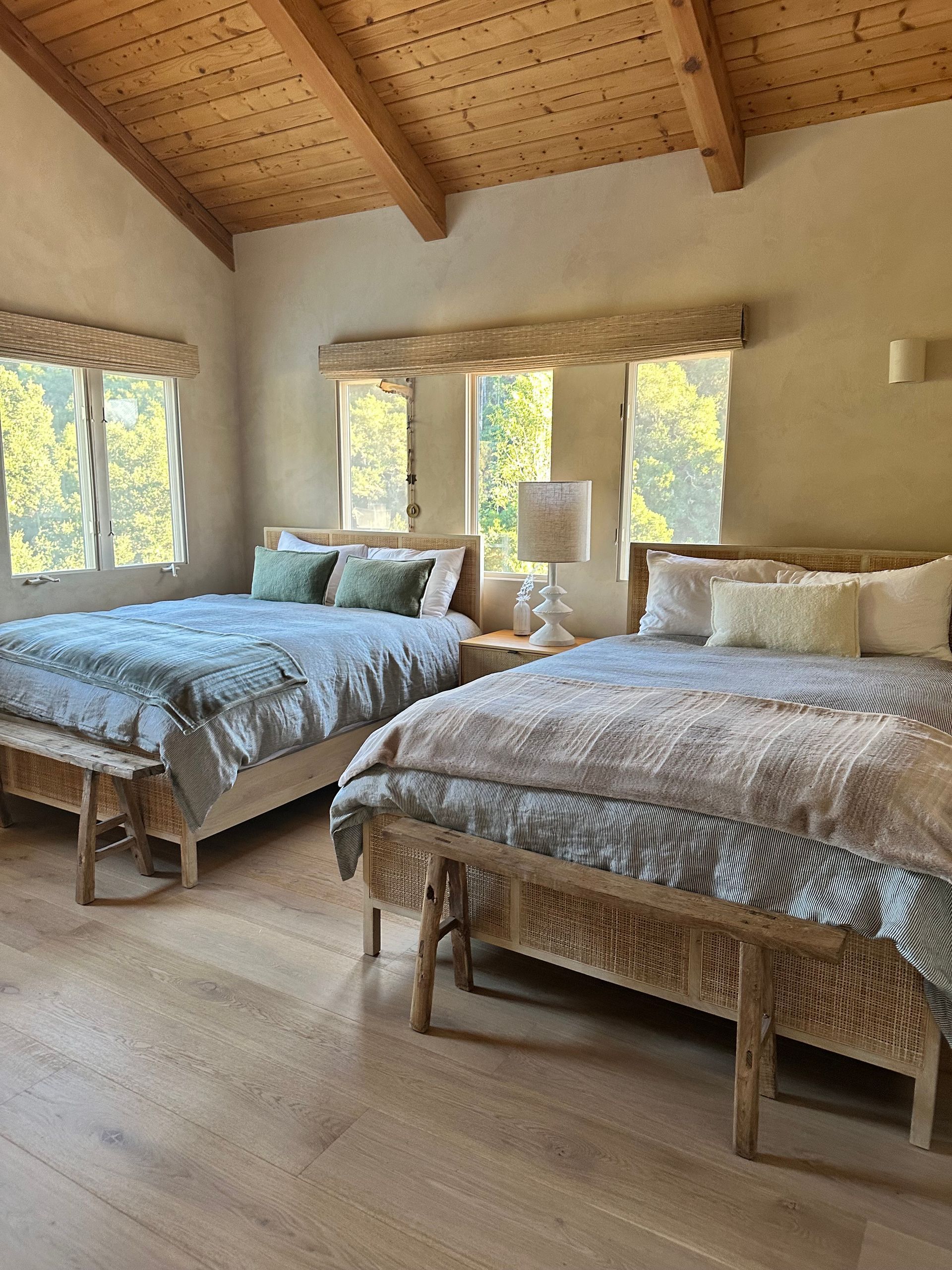 A bed with white sheets and pillows in a bedroom.