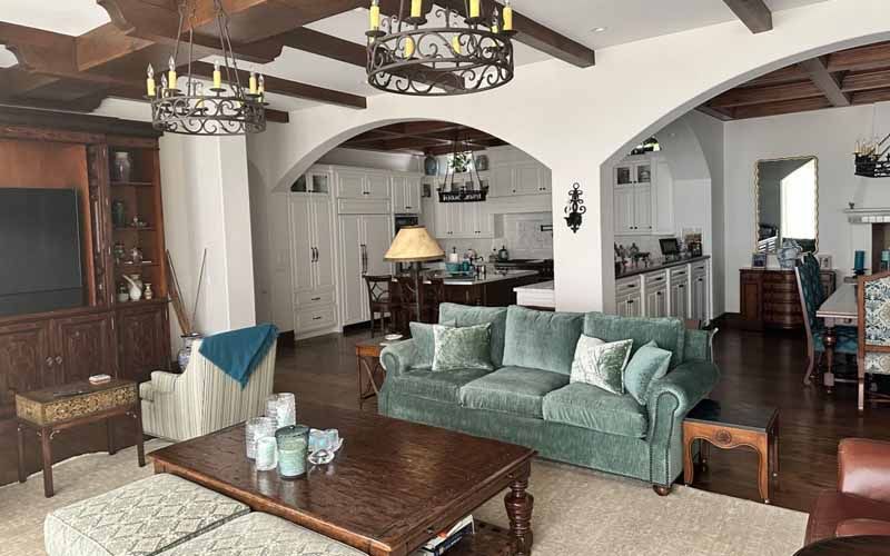 A living room with a green couch and a wooden coffee table.