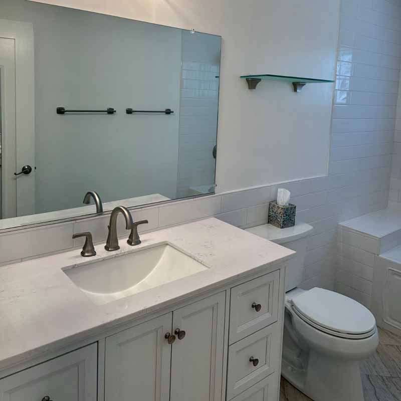 A bathroom with a sink , toilet , and mirror.