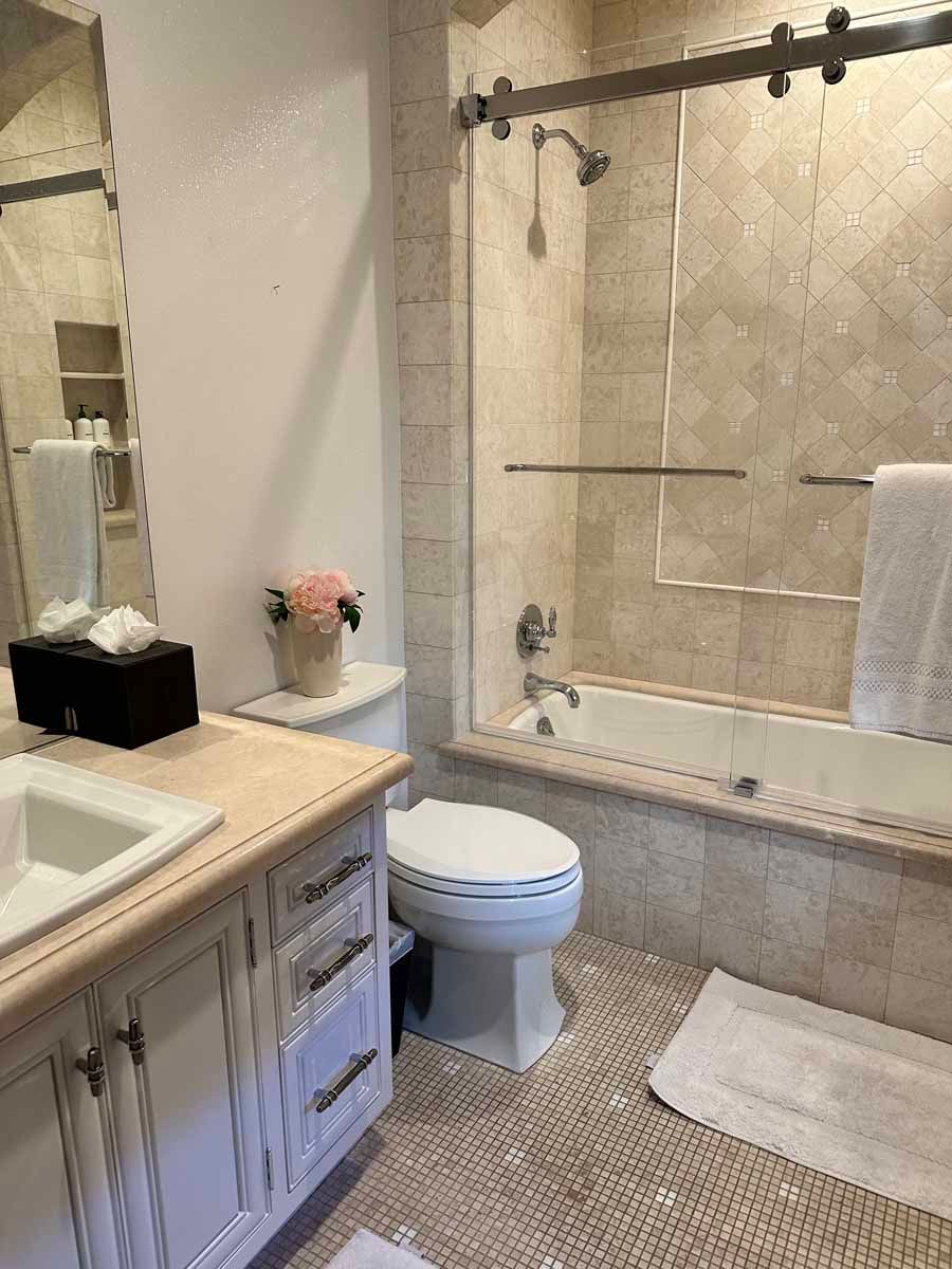 A bathroom with a toilet , sink , tub and shower.