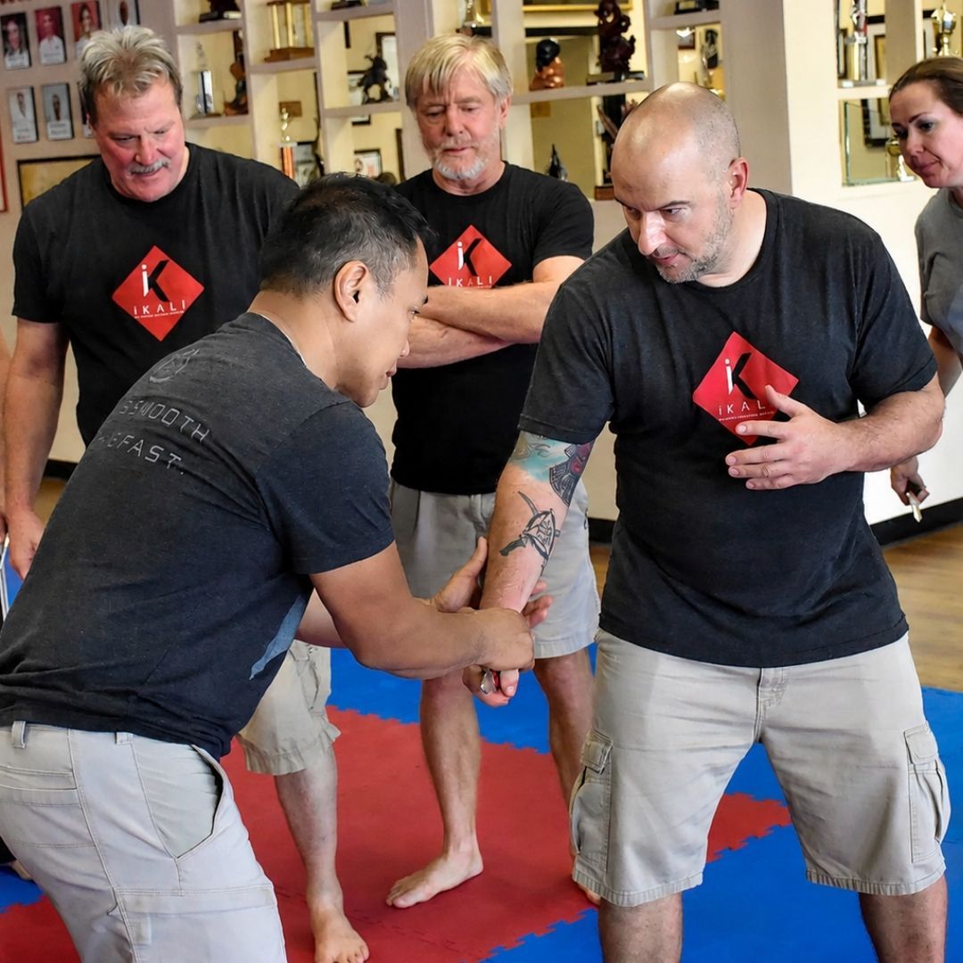 Two people practicing Brazilian Jiu-Jitsu on a mat. One is on top, applying a hold.