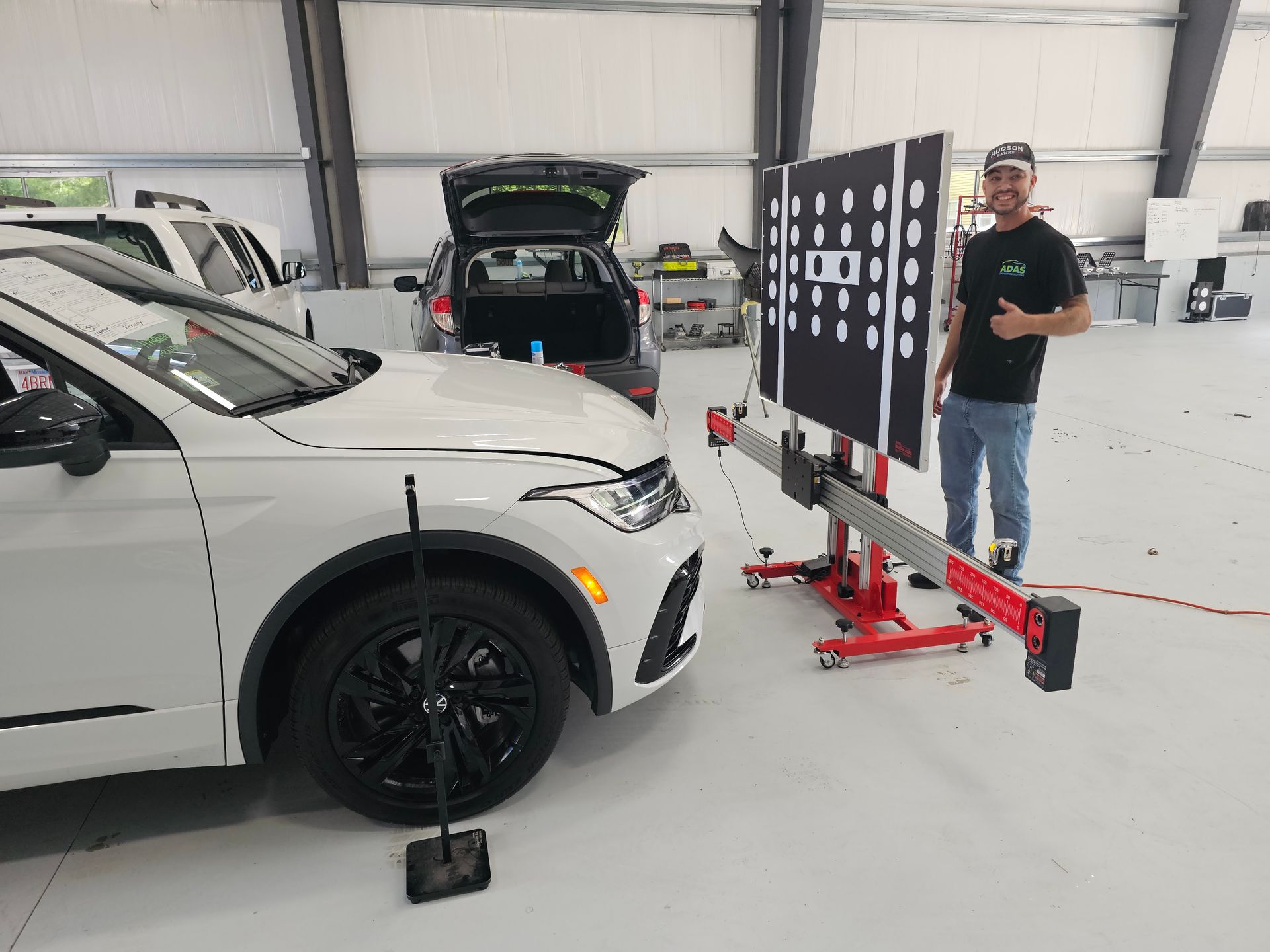 A white ford mustang is being washed in a car wash.