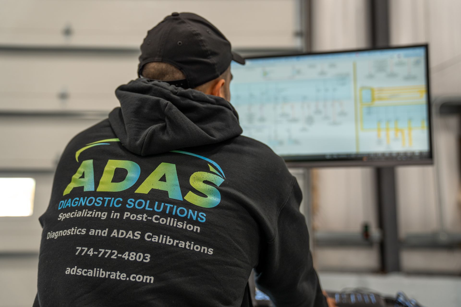 A man and a woman are driving down a highway at night.