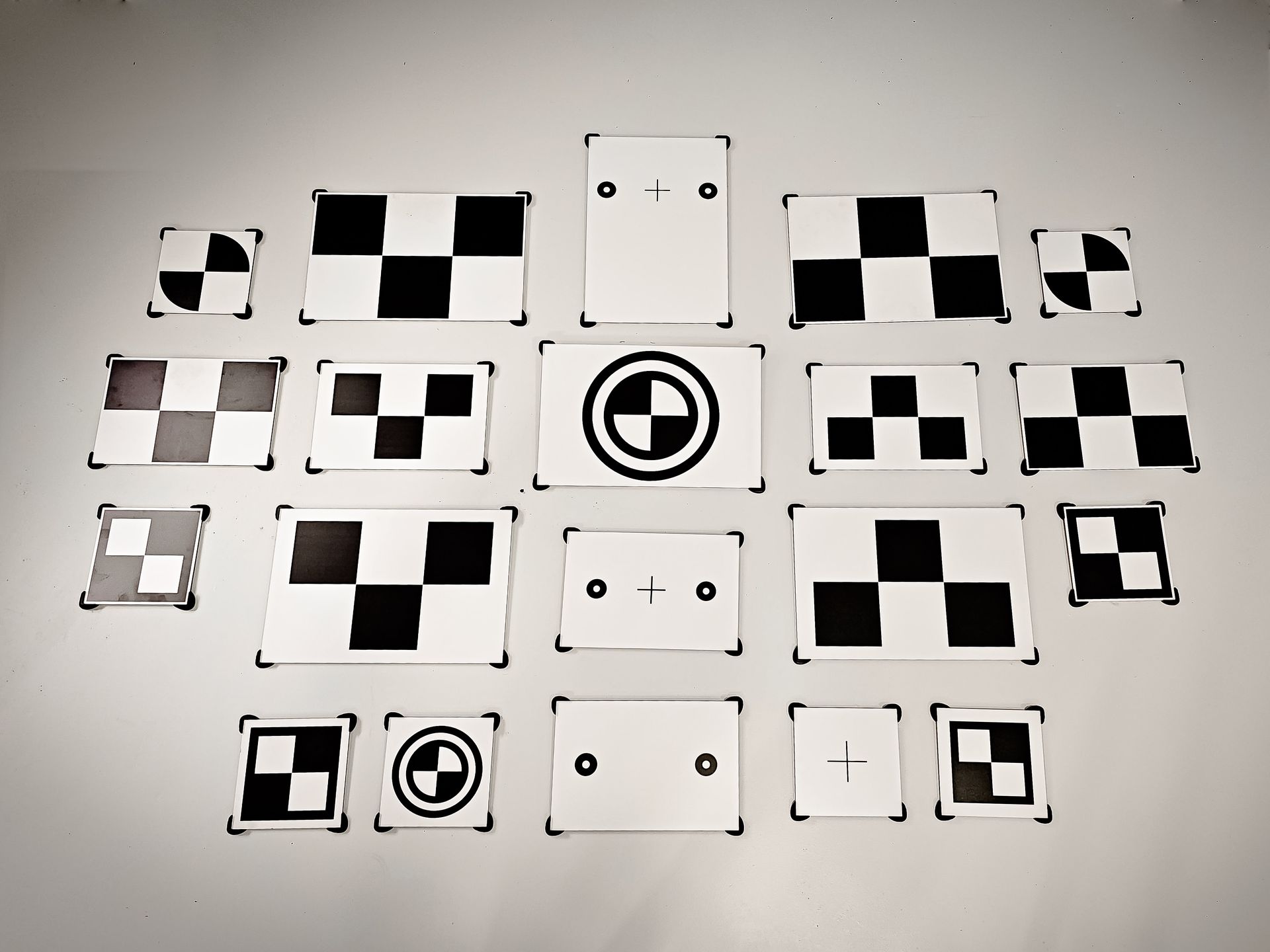 A white car is driving through a dirt field.