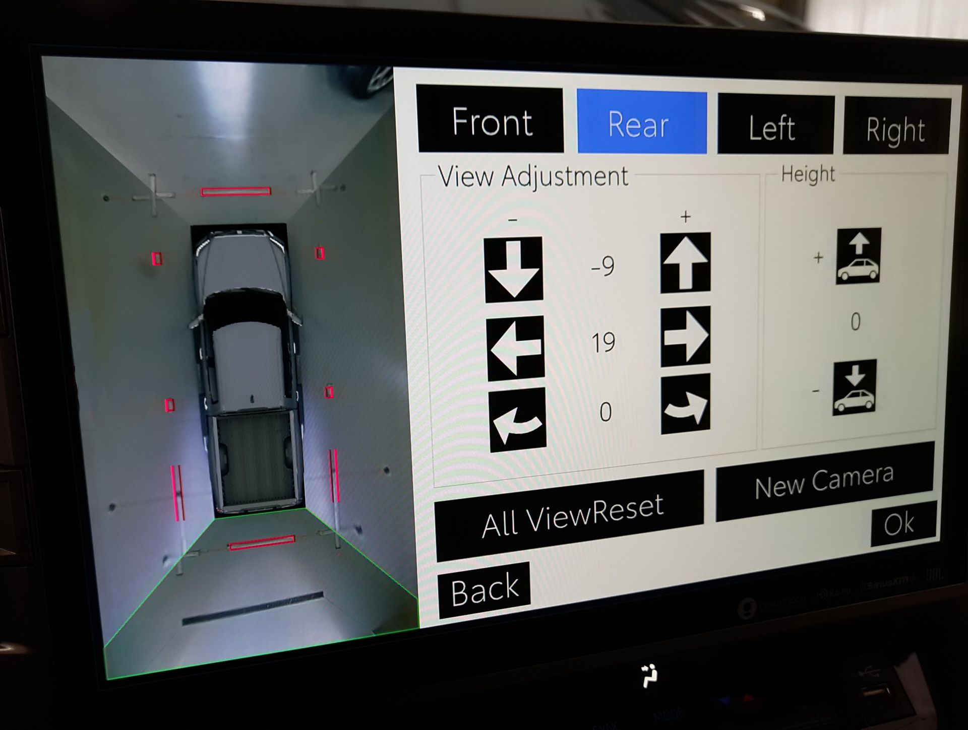 A man is working on the engine of a car in a garage.